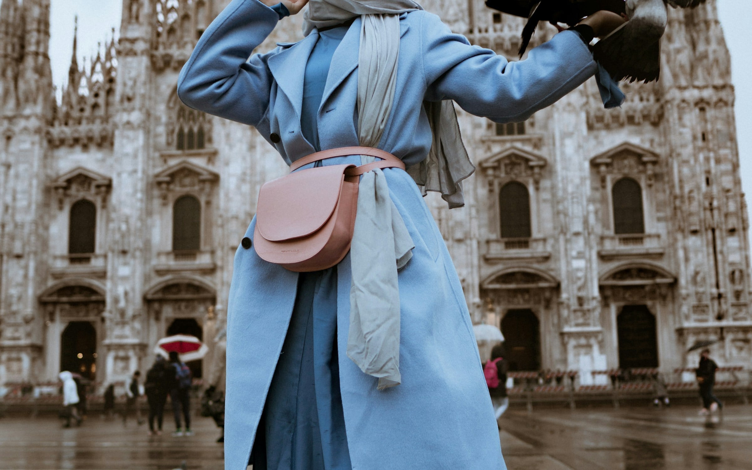 A split image showing a person in a plain top on the left, and the same person rendered wearing a tailored coat on the right.