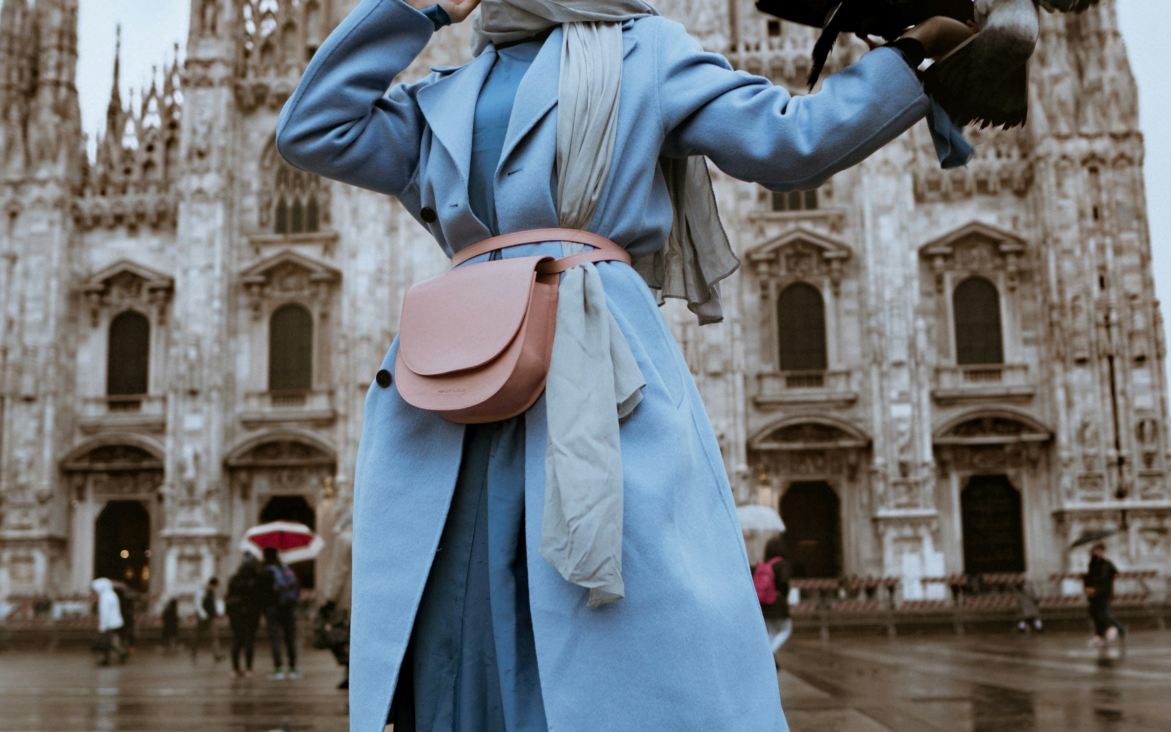 A split image showing a person in a plain top on the left, and the same person rendered wearing a tailored coat on the right.